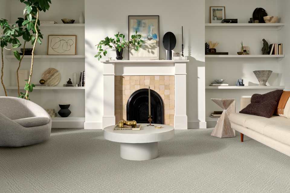 beige patterned carpet in modern neutral living room with fireplace and coffee table